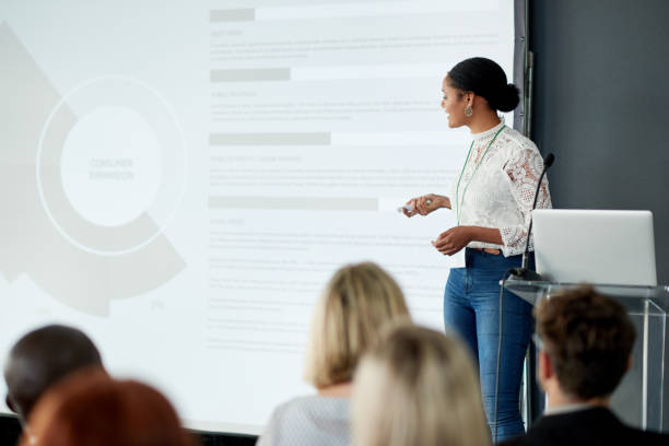 Shot of a young businesswoman delivering a presentation at a conference